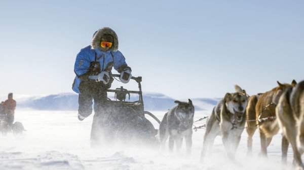 Dog sled expedition in arctic landscape by Fjällräven