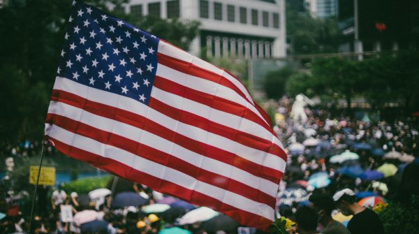 US flag over crowd